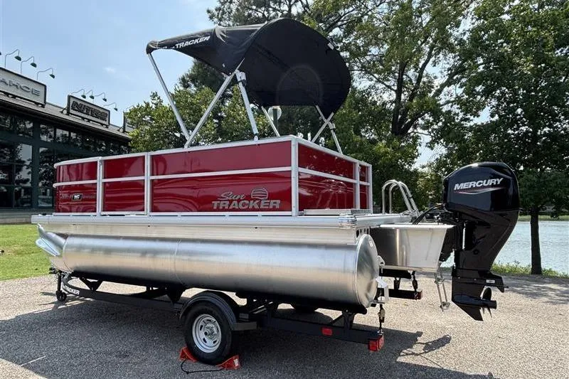 Slide: The Image of 2026 Sun Tracker Party Barge 16 DLX pontoon boat with Mercury outboard motor on trailer. - 3