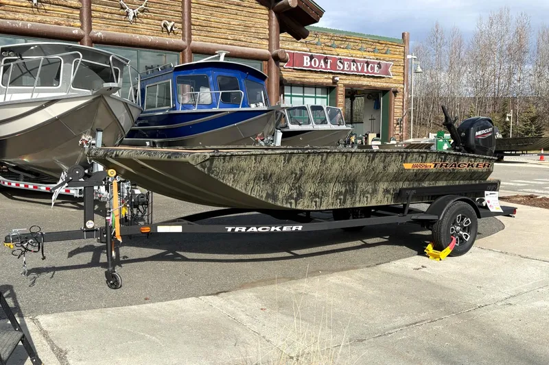 The Image of 2026 Tracker Grizzly 1756 T Marsh boat on trailer outside boat service shop. - 0