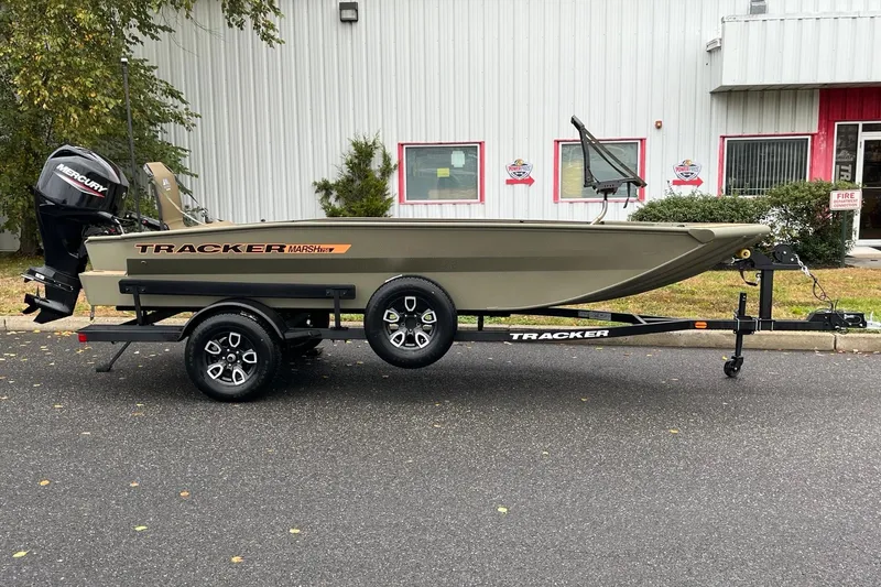 The Image of 2026 Tracker Grizzly 1756 T Marsh boat on trailer, parked outdoors. - 0