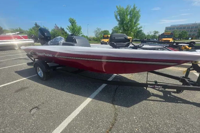 The Image of 2026 Tracker Bass Tracker Classic XL boat in parking lot, red and white design. - 0