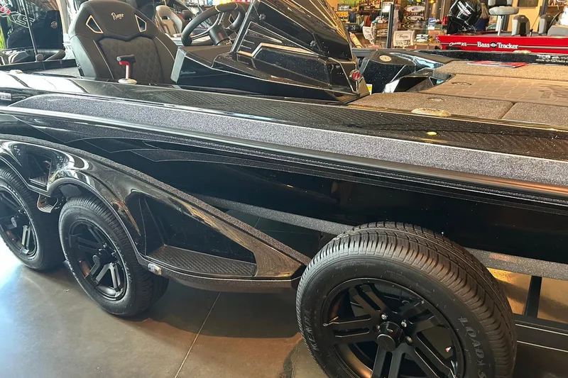Slide: The Image of 2026 Ranger Z521R Cup-Equipped boat, sleek black design, dual wheels, showroom display. - 1
