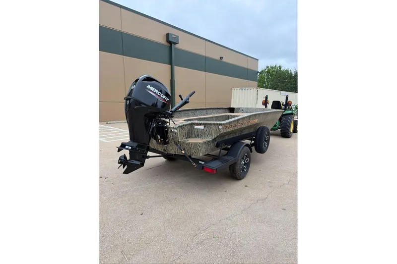 The Image of 2026 Tracker Grizzly 1756 T Marsh boat with Mercury engine on trailer, parked outdoors. - 0