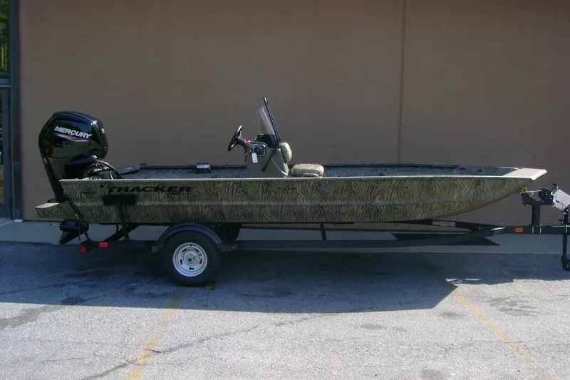 The Image of 2026 Tracker Grizzly 1860 CC boat on trailer, featuring a Mercury outboard motor. - 0