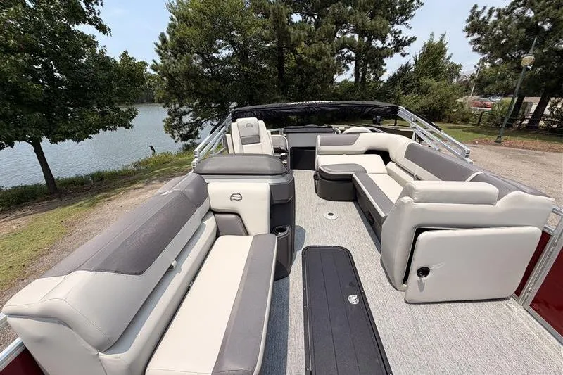 Slide: The Image of 2026 Sun Tracker Fishin' Barge 22 XP3 pontoon boat with spacious seating near a lake. - 10