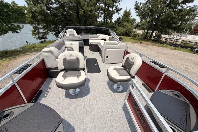 Slide: The Image of 2026 Sun Tracker Fishin' Barge 22 XP3 pontoon boat with spacious seating and scenic lake view. - 8