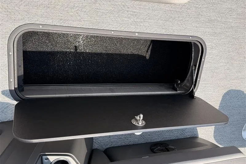 Slide: The Image of Open storage compartment on 2026 Sun Tracker Fishin' Barge 22 XP3 boat. - 20