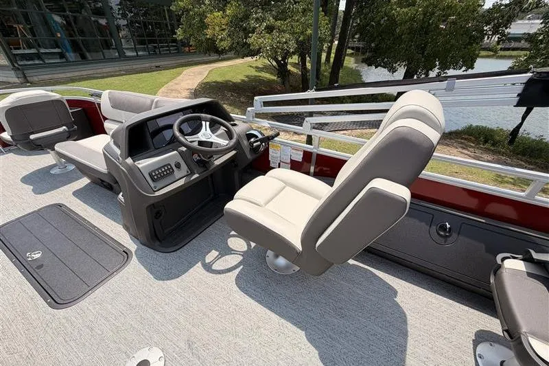 Slide: The Image of 2026 Sun Tracker Fishin' Barge 22 XP3 interior with steering console and seating. - 15