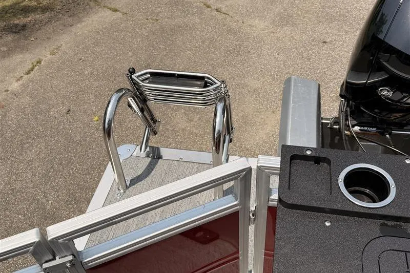 Slide: The Image of 2026 Sun Tracker Fishin' Barge 22 XP3 boat ladder and motor detail. - 22