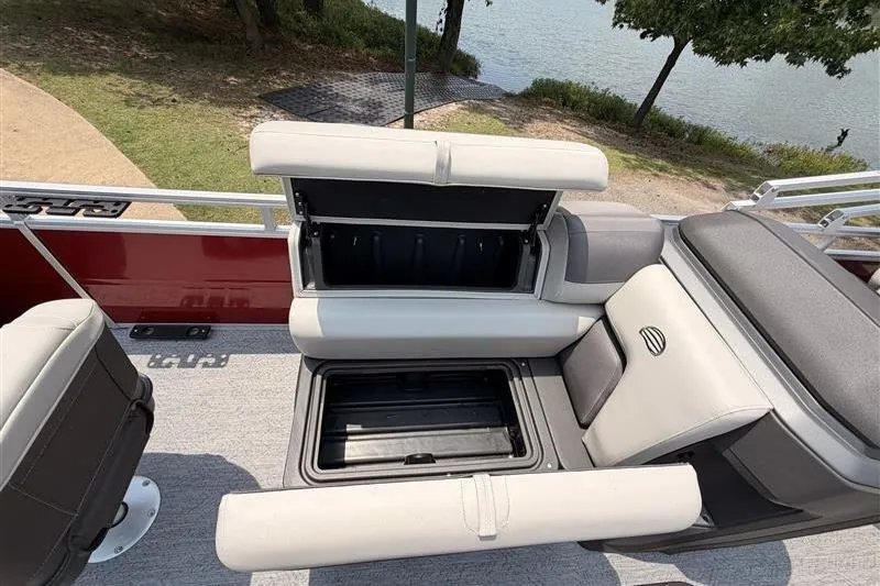 Slide: The Image of 2026 Sun Tracker Fishin' Barge 22 XP3 with open storage compartments on deck. - 12