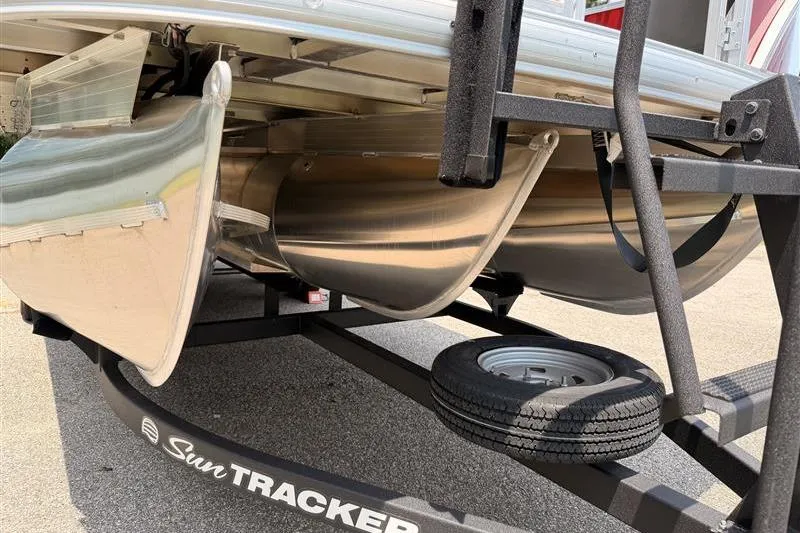 Slide: The Image of 2026 Sun Tracker Fishin' Barge 22 XP3 pontoon boat on trailer, close-up view. - 7