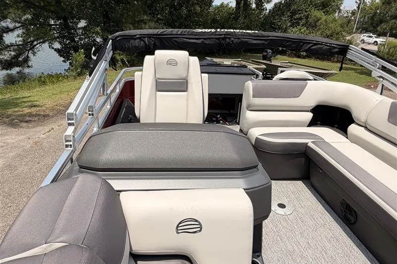 Slide: The Image of 2026 Sun Tracker Fishin' Barge 22 XP3 interior with plush seating and scenic lake view. - 14