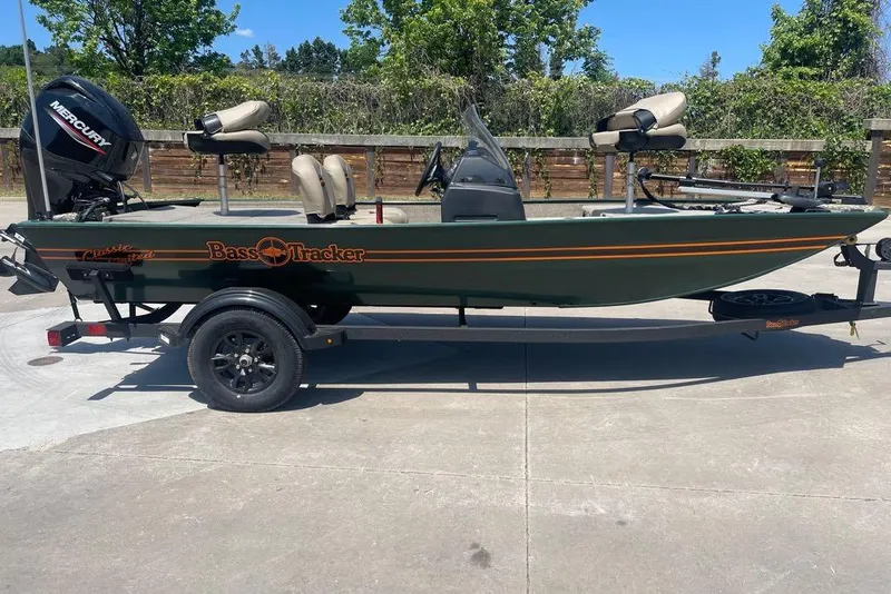 The Image of 2026 Tracker Bass Tracker Classic Limited fishing boat on trailer, outdoors. - 0