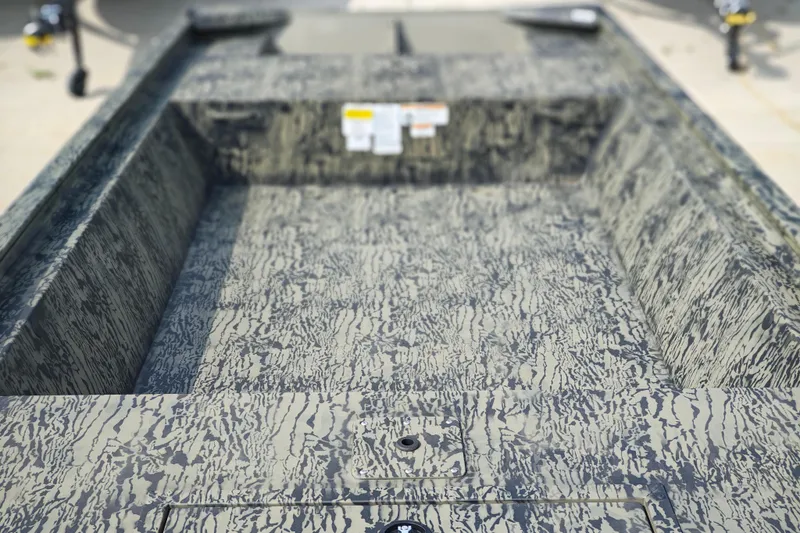 Slide: The Image of 2026 Tracker Grizzly 1648 Utility boat interior with camouflage pattern design. - 4