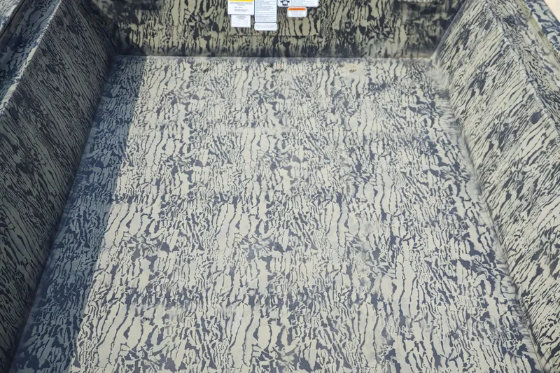 Slide: The Image of 2026 Tracker Grizzly 1648 Utility boat interior with camouflage pattern design. - 5
