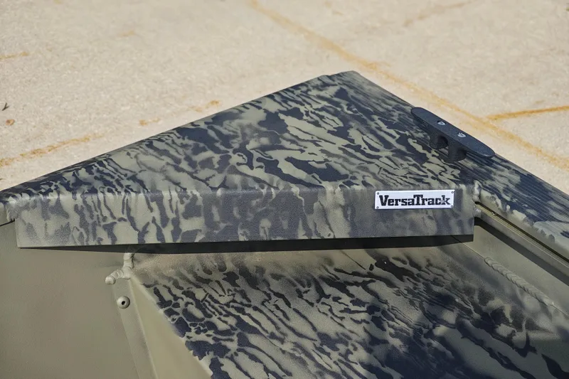 Slide: The Image of 2026 Tracker Grizzly 1648 Utility boat with camo pattern and VersaTrack system. - 14