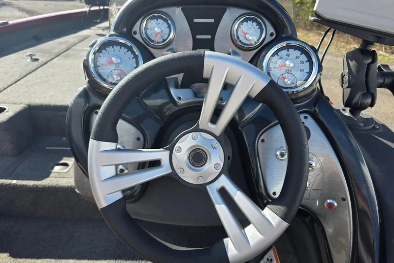 Slide: The Image of 2019 Tracker Pro Team 190 TX Tournament Edition boat dashboard with steering wheel and gauges. - 16