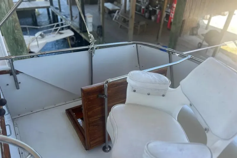 Slide: The Image of 1978 Chris-Craft 45 Commander boat deck with white seating and wooden accents. - 13