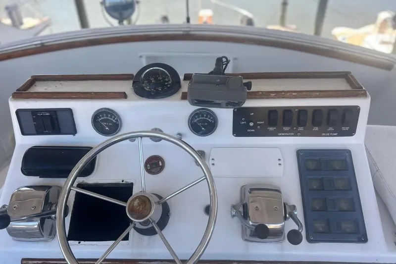 Slide: The Image of 1978 Chris-Craft 45 Commander helm with steering wheel and control panel. - 14