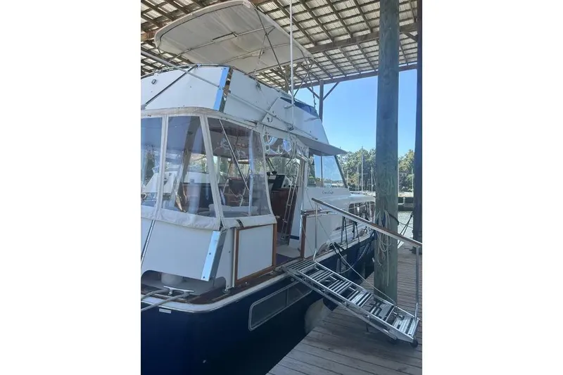 Slide: The Image of 1978 Chris-Craft 45 Commander yacht docked under a covered marina. - 15