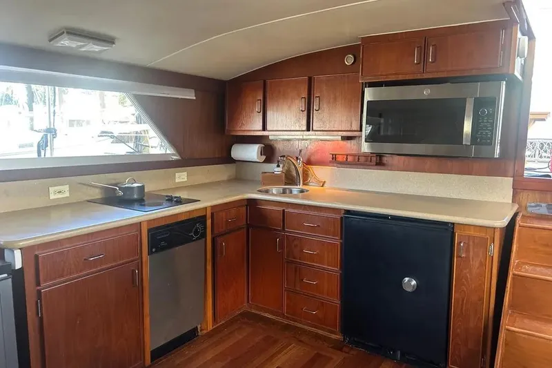 Slide: The Image of 1978 Chris-Craft 45 Commander yacht kitchen with wooden cabinets and modern appliances. - 18