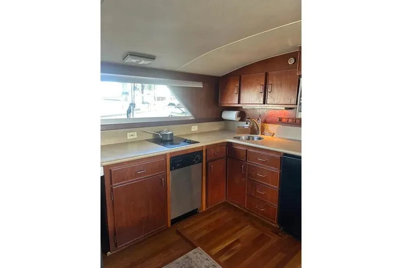 Slide: The Image of 1978 Chris-Craft 45 Commander yacht kitchen with wooden cabinets and modern appliances. - 20