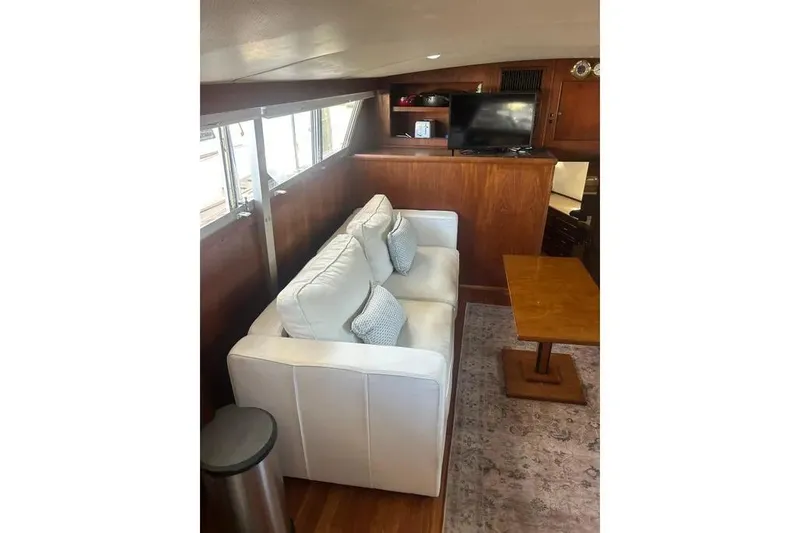 Slide: The Image of Interior of 1978 Chris-Craft 45 Commander with white sofa and wooden table. - 24