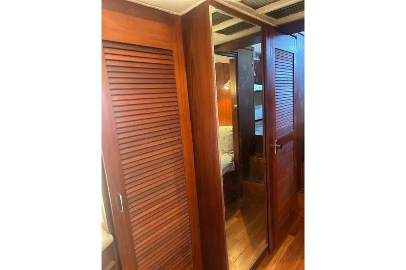 Slide: The Image of Interior of 1978 Chris-Craft 45 Commander with wooden cabinetry and mirrored door. - 28
