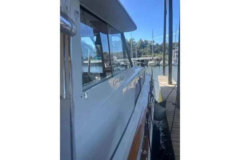 Slide: The Image of 1978 Chris-Craft 45 Commander yacht docked at marina, side view. - 3