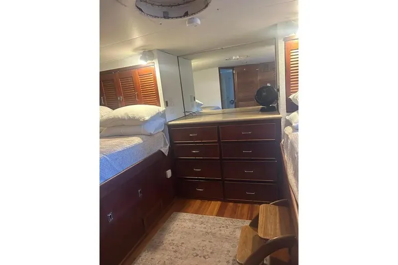 Slide: The Image of Interior of 1978 Chris-Craft 45 Commander yacht with wooden cabinetry and bedding. - 36