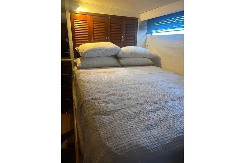 Slide: The Image of Cozy bedroom interior on 1978 Chris-Craft 45 Commander yacht with wooden cabinets. - 37