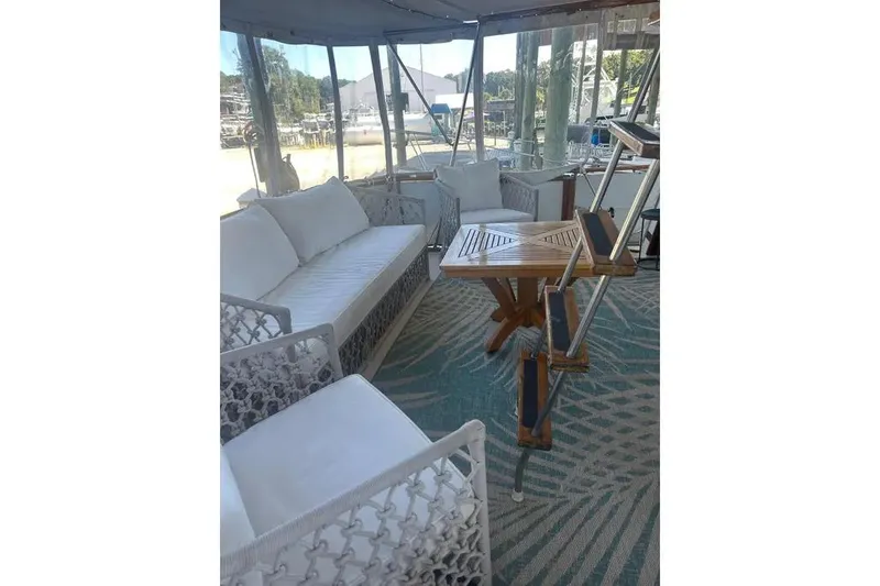 Slide: The Image of Interior of 1978 Chris-Craft 45 Commander with white seating and wooden table. - 39