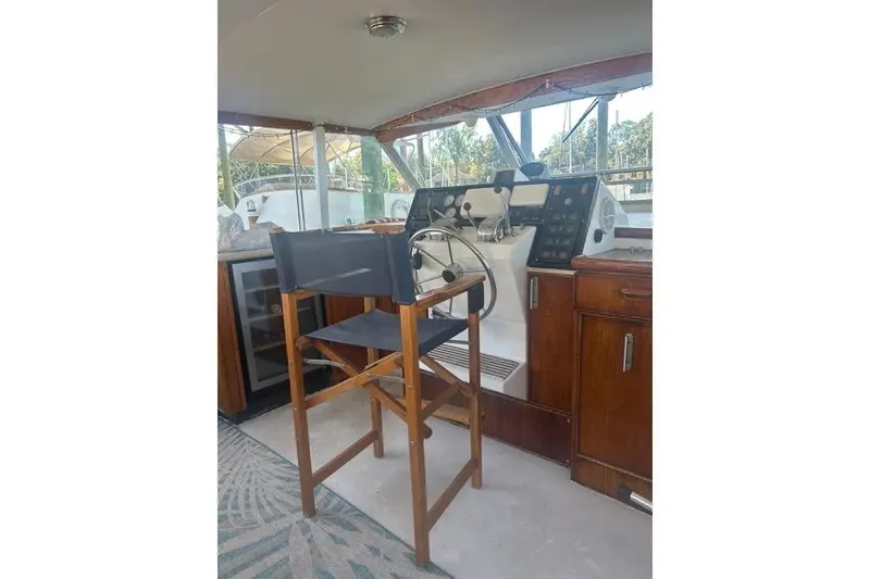 Slide: The Image of 1978 Chris-Craft 45 Commander helm with wooden chair and control panel. - 41