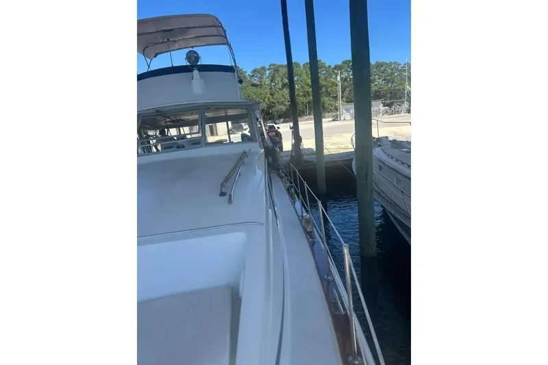 Slide: The Image of 1978 Chris-Craft 45 Commander yacht docked, side view with clear blue sky. - 6
