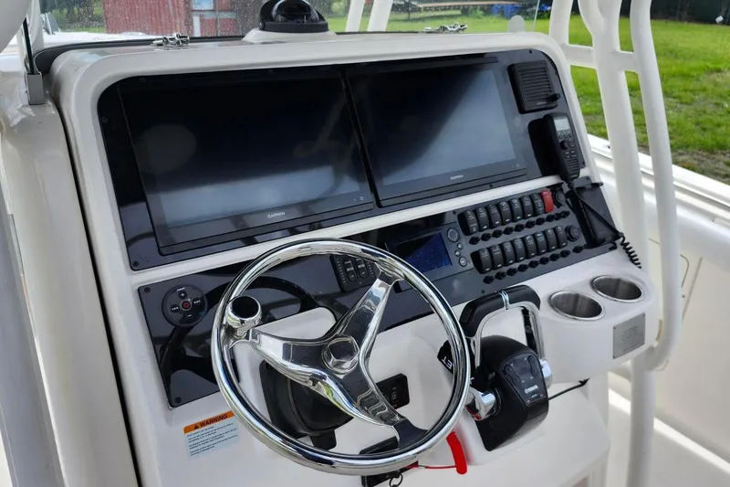 Slide: The Image of 2015 Robalo R300 Center Console helm with dual displays and controls. - 20