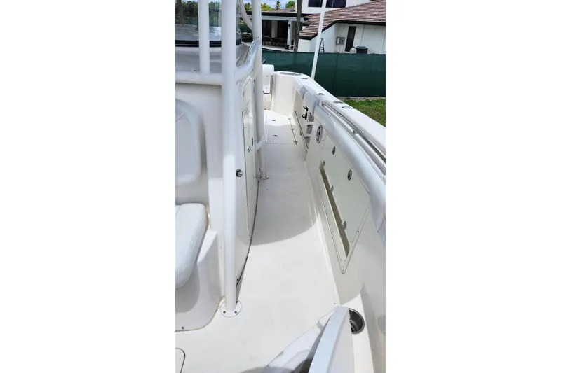 Slide: The Image of 2015 Robalo R300 Center Console boat deck with seating and storage compartments. - 27