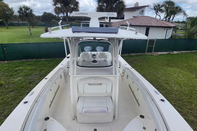 Slide: The Image of 2015 Robalo R300 Center Console boat with Garmin equipment, docked on grassy area. - 31