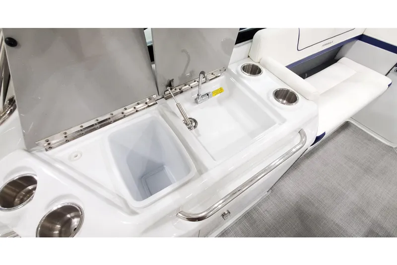 Slide: The Image of 2013 Formula 310 Bowrider interior with sink, cup holders, and seating area. - 12