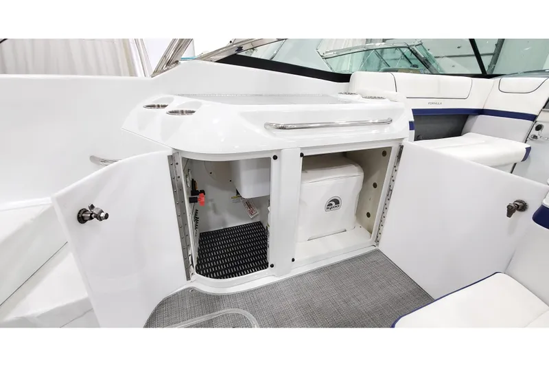 Slide: The Image of 2013 Formula 310 Bowrider interior with open storage compartment and seating area. - 13