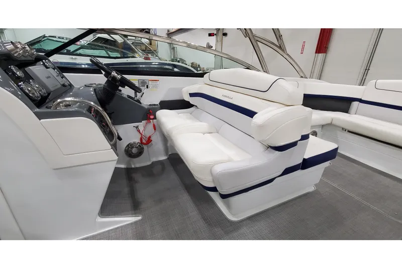 Slide: The Image of 2013 Formula 310 Bowrider interior with white seating and modern dashboard. - 16
