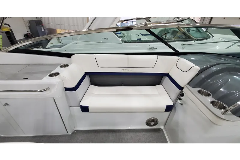 Slide: The Image of 2013 Formula 310 Bowrider interior with white seating and cup holders. - 19