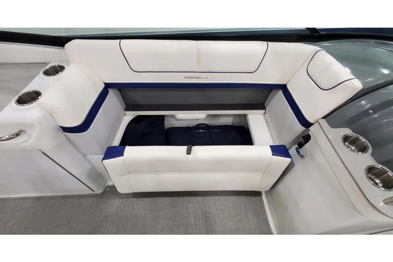 Slide: The Image of 2013 Formula 310 Bowrider interior with white and blue seating and storage compartment. - 20