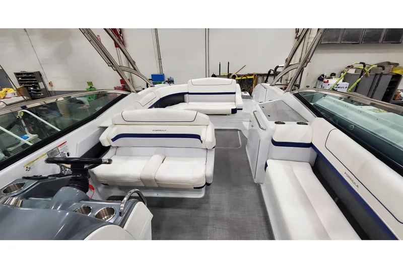 Slide: The Image of 2013 Formula 310 Bowrider interior with white seating and steering console. - 22