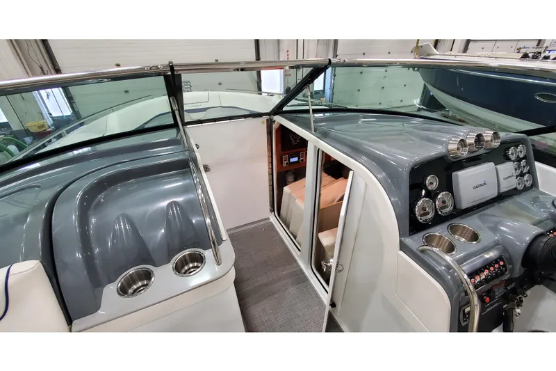 Slide: The Image of 2013 Formula 310 Bowrider cockpit with sleek dashboard, Garmin navigation, and cup holders. - 24