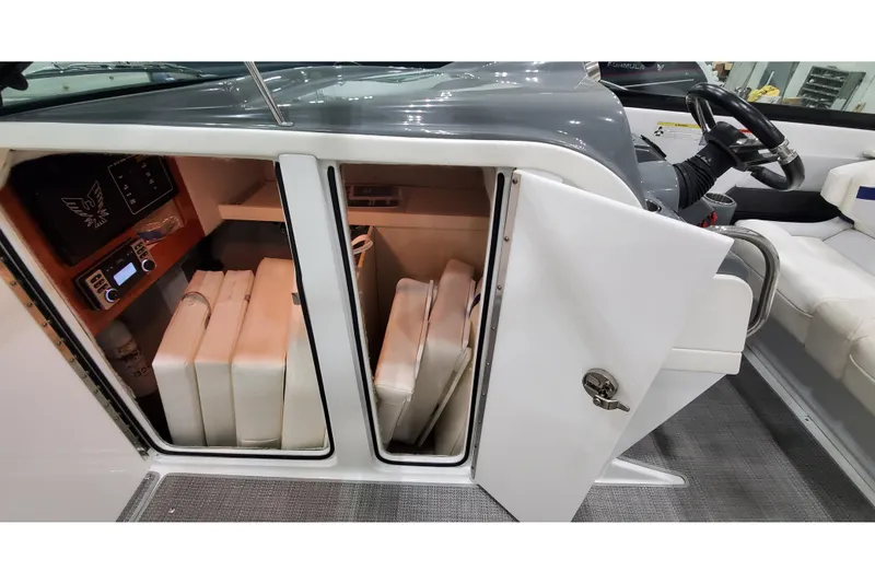 Slide: The Image of 2013 Formula 310 Bowrider interior storage with cushions and control panel. - 25