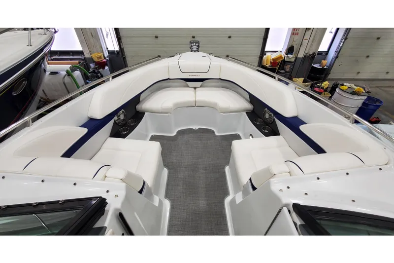 Slide: The Image of 2013 Formula 310 Bowrider interior with spacious seating and modern design in a garage setting. - 26