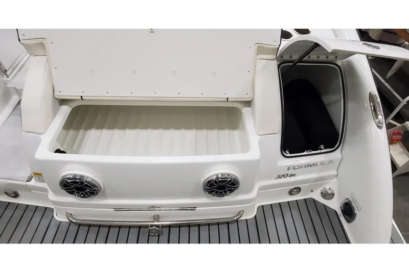 Slide: The Image of 2013 Formula 310 Bowrider boat interior with storage compartments and speakers. - 3