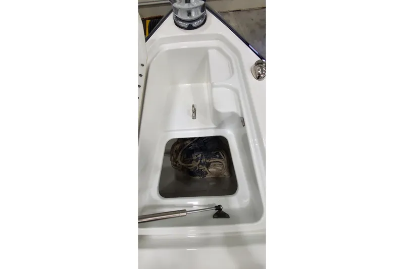 Slide: The Image of 2013 Formula 310 Bowrider storage compartment with rope inside. - 30