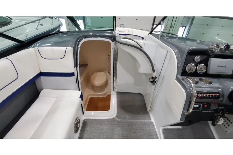 Slide: The Image of 2013 Formula 310 Bowrider interior with seating, helm, and compact restroom. - 38