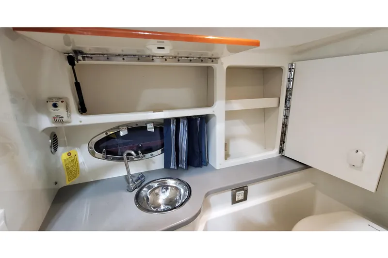 Slide: The Image of 2013 Formula 310 Bowrider interior cabin with sink and storage compartments. - 39