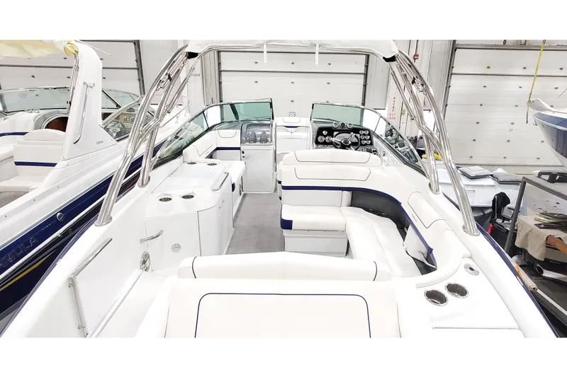 Slide: The Image of 2013 Formula 310 Bowrider interior with sleek white seating and modern dashboard. - 4